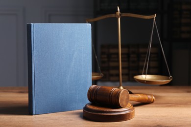 Photo of Law. Book, gavel and scales on wooden table
