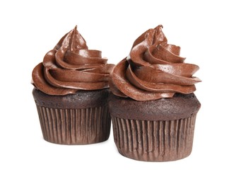 Delicious chocolate cupcakes with cream on white background