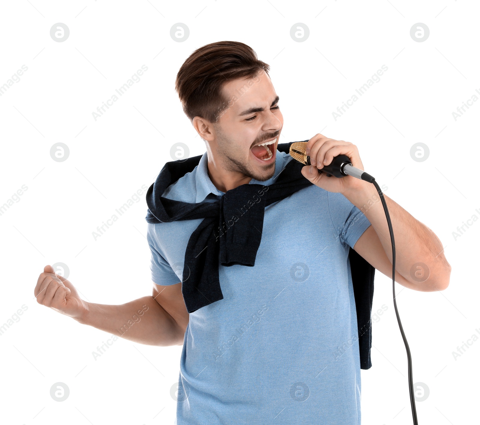 Photo of Young handsome man in casual clothes singing with microphone on white background