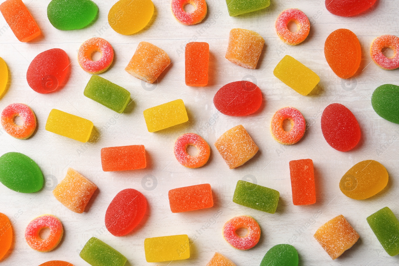 Photo of Flat lay composition with delicious jelly candies on wooden background