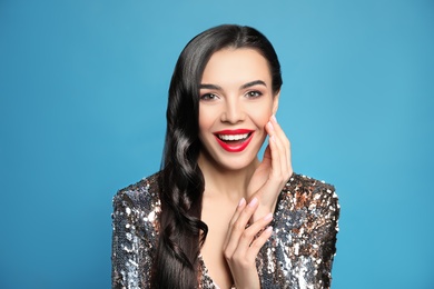 Portrait of surprised woman on blue background