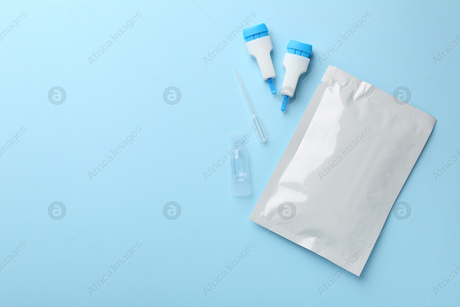 Photo of Disposable express test kit on light blue background, flat lay. Space for text