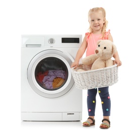 Photo of Cute little girl holding laundry basket with teddy bear near washing machine on white background