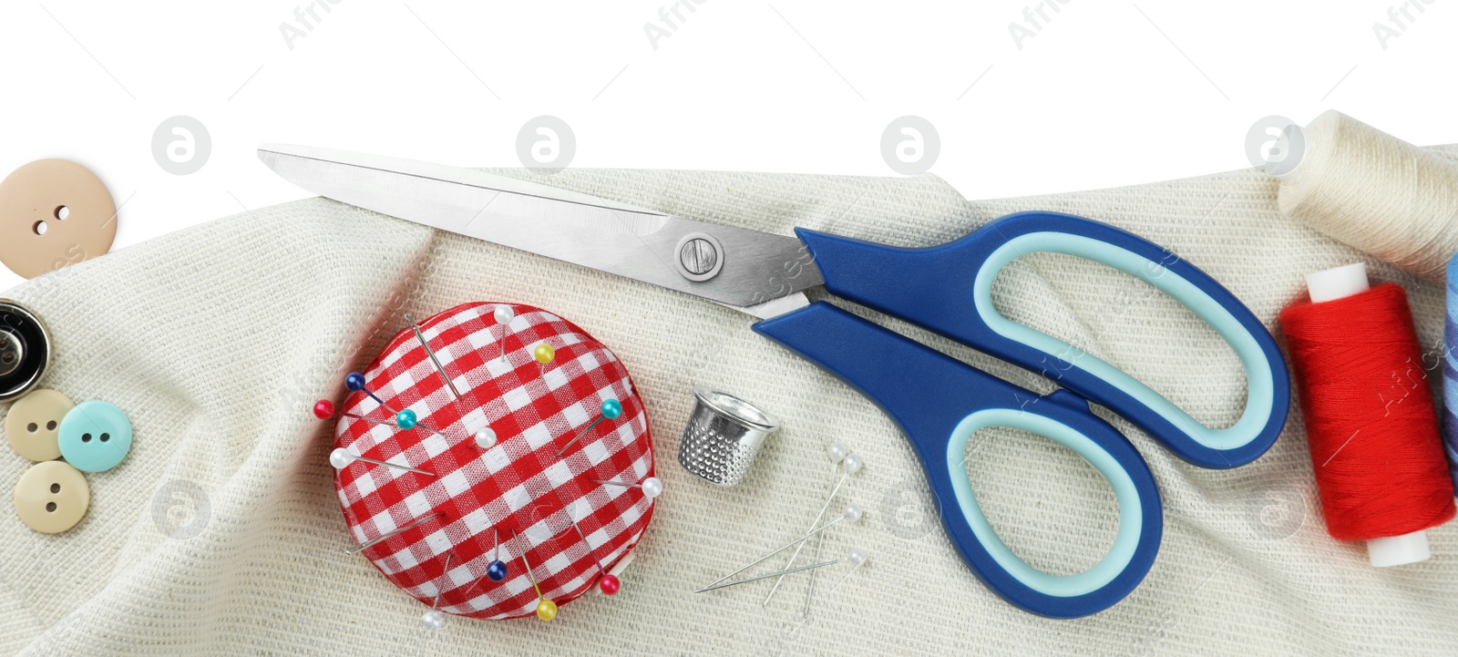 Photo of Set of different sewing accessories on white background, top view