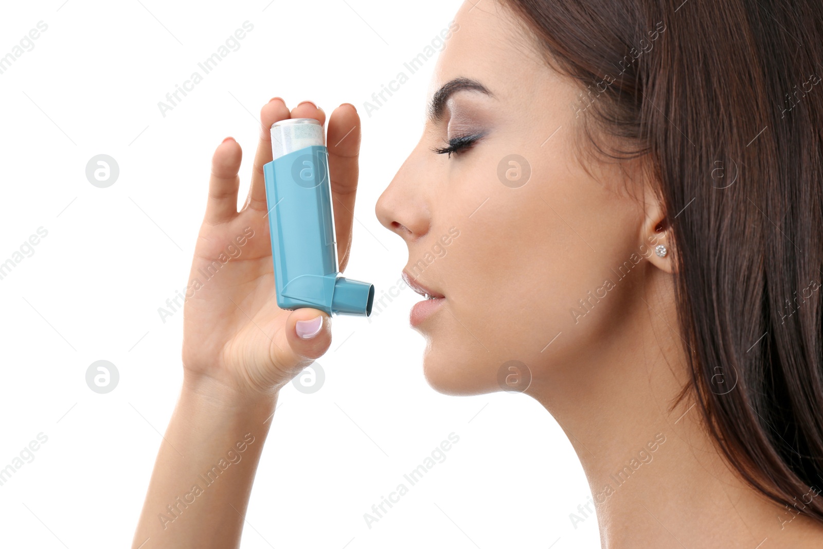 Photo of Young woman using asthma inhaler on white background