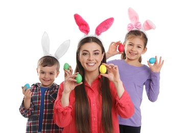 Photo of Cute family in bunny ears headbands holding Easter eggs on white background