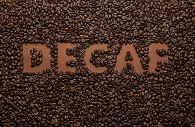 Photo of Word Decaf in coffee beans, top view