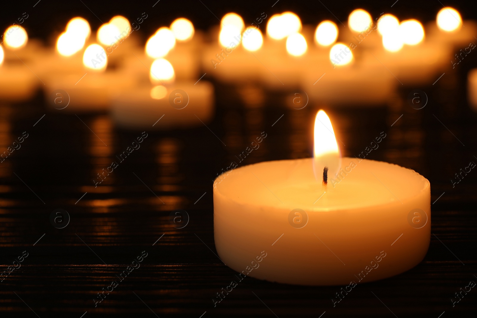 Photo of Burning candle on table, space for text