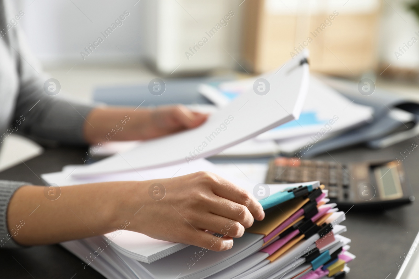 Photo of Office employee working with documents at table, closeup