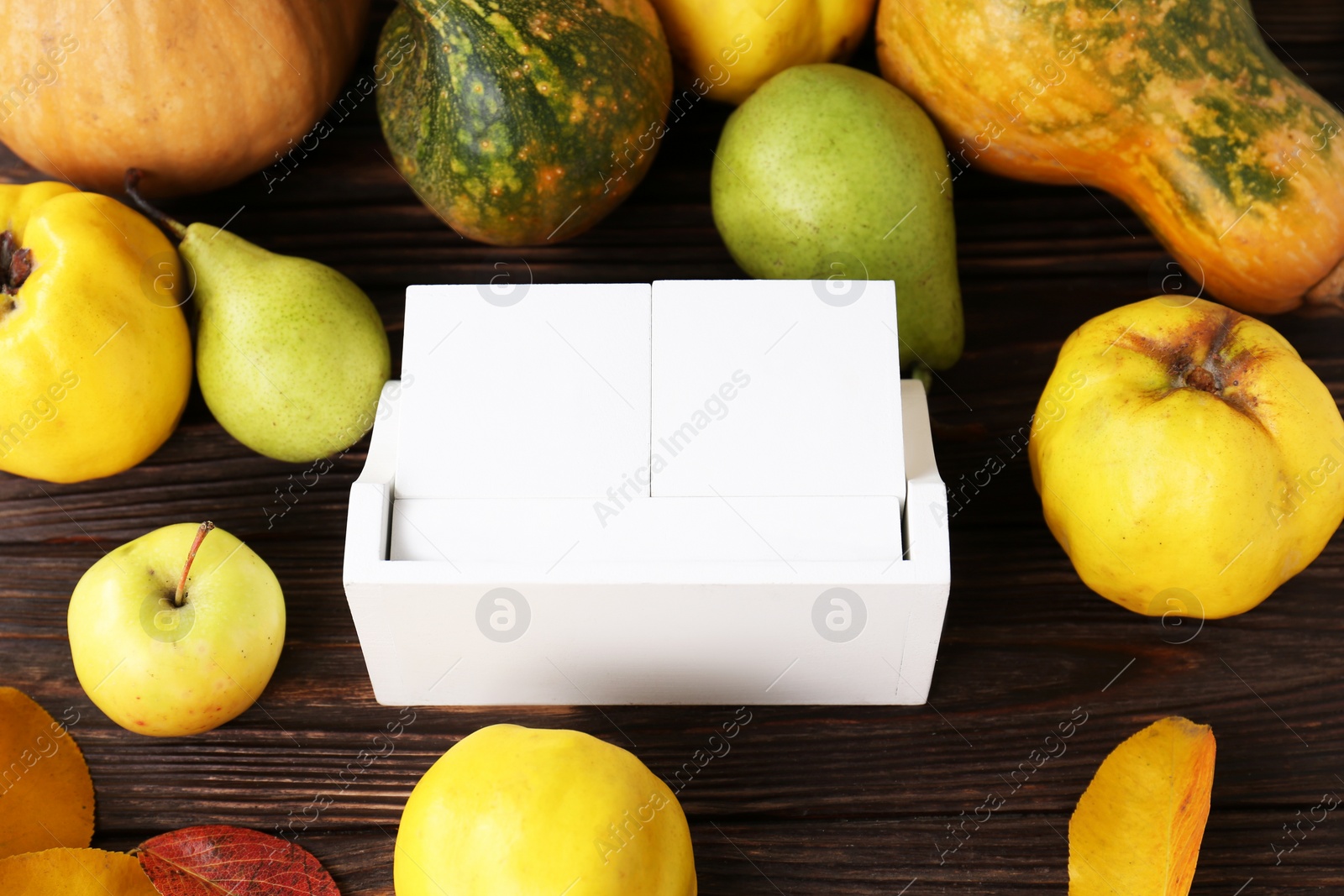 Photo of Thanksgiving day, holiday celebrated every fourth Thursday in November. Block calendar, fruits, vegetables and autumn leaves on wooden table