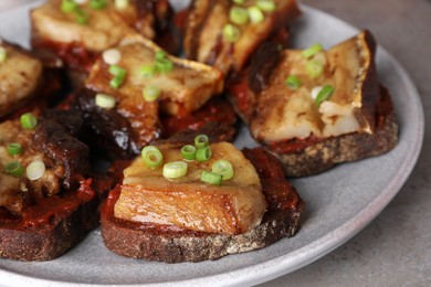 Tasty sandwiches with fried pork fatback slices on grey table, closeup