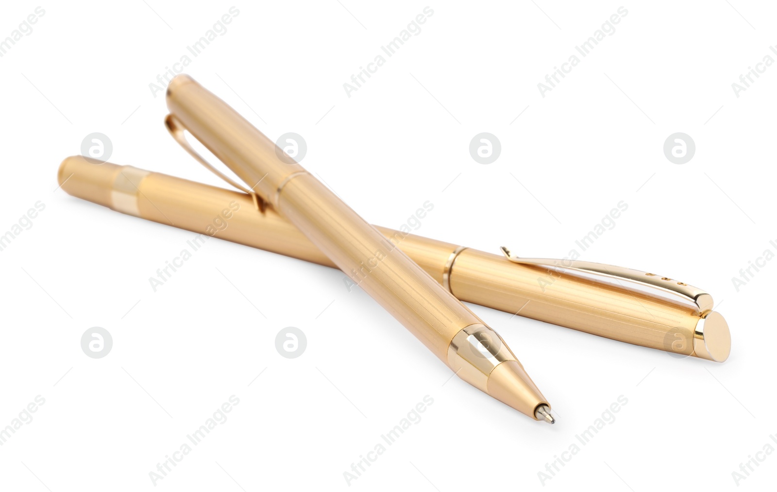 Photo of New stylish golden pens isolated on white, closeup