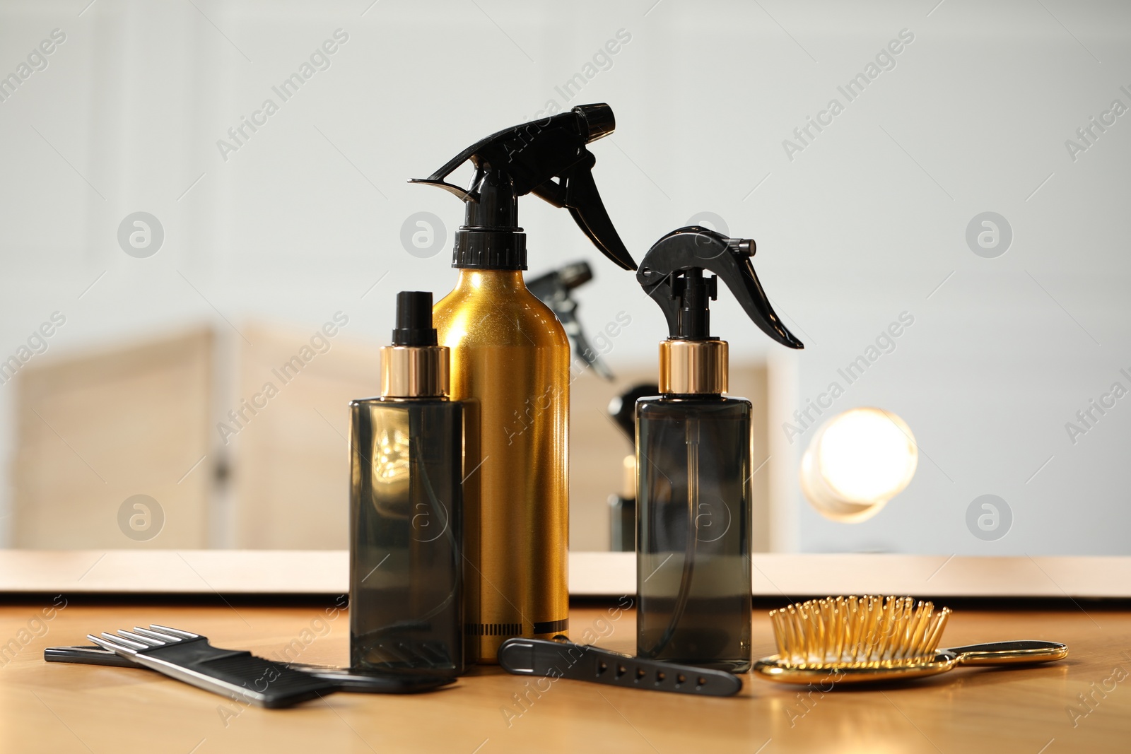 Photo of Set of hairdresser tools on table in salon