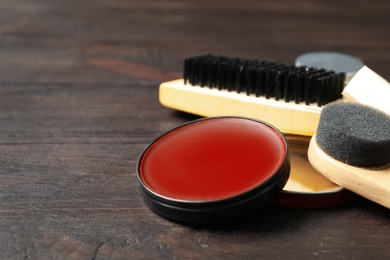 Composition with shoe care accessories on wooden background, closeup