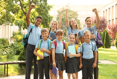 Photo of Group of children in stylish school uniform outdoors