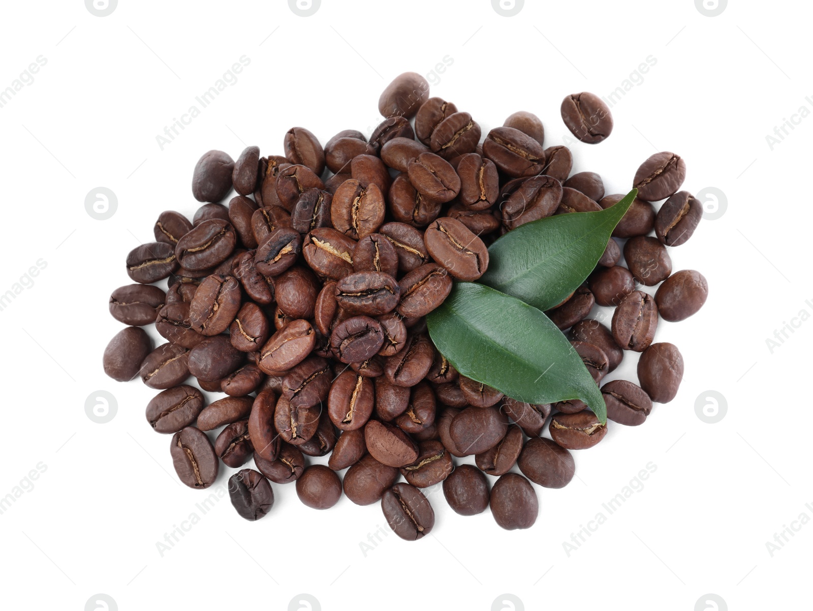 Photo of Pile of roasted coffee beans with fresh leaves on white background, top view