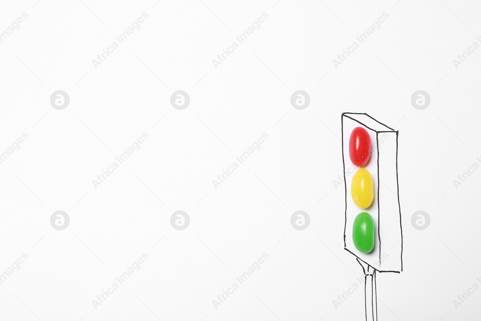 Photo of Colorful jelly candies arranged as traffic light on white background, top view