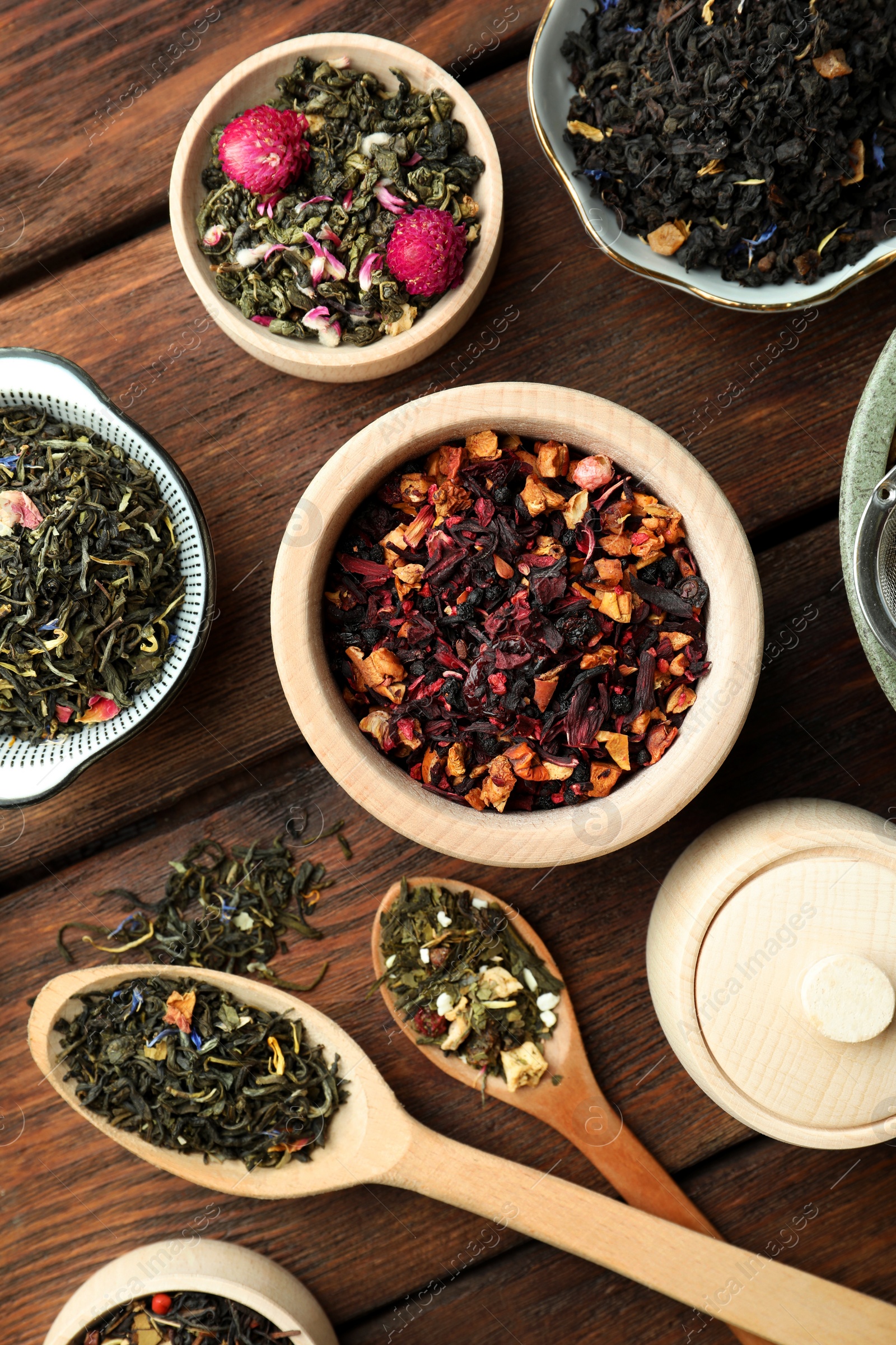 Photo of Many different herbal teas on wooden table, flat lay