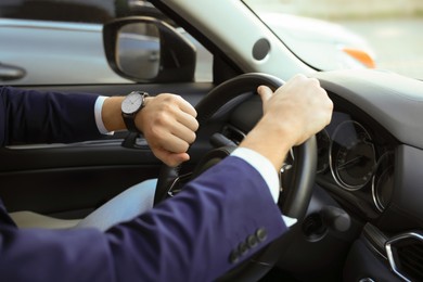 Photo of Man checking time in car, closeup. Being late