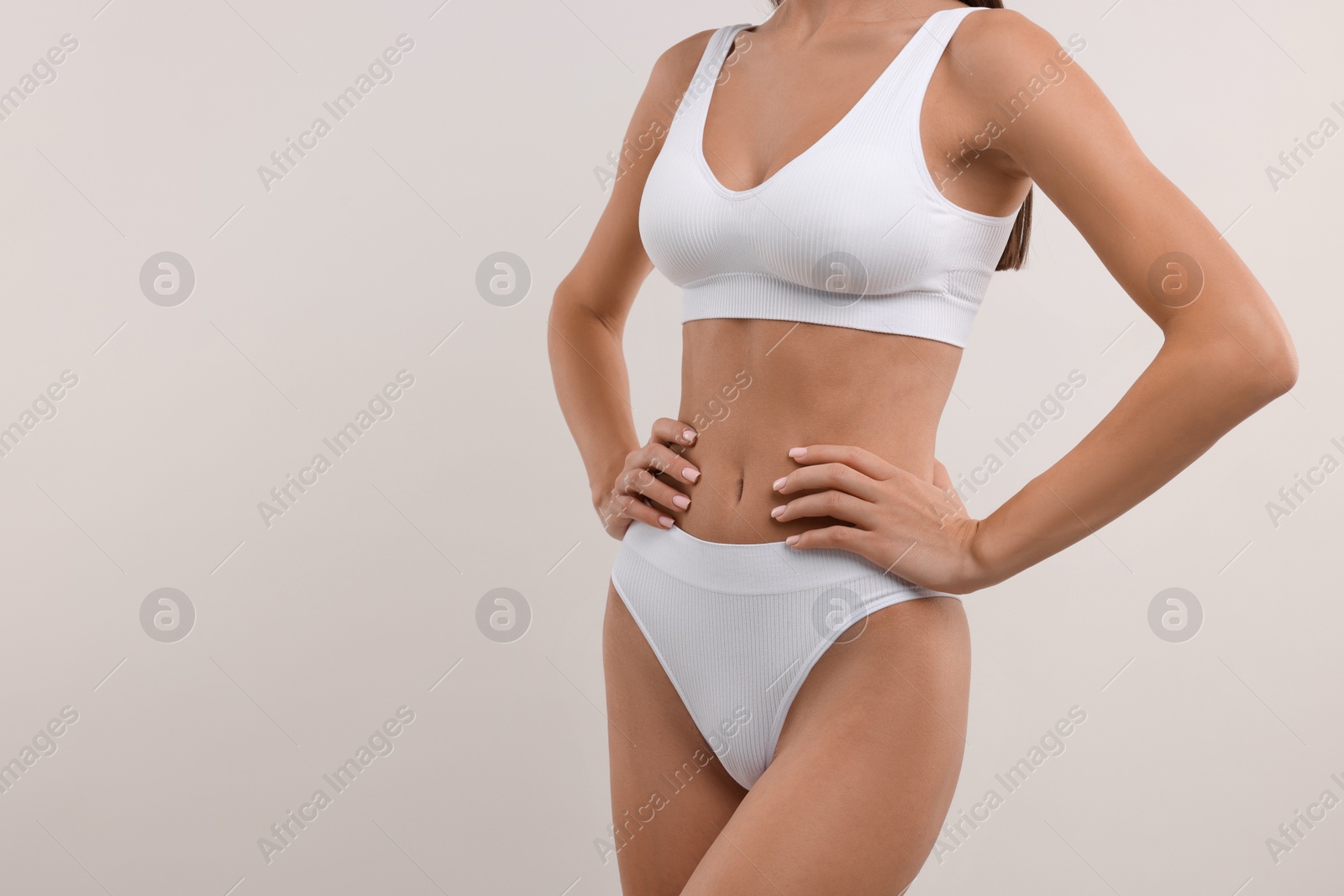 Photo of Young woman in stylish bikini on white background, closeup. Space for text