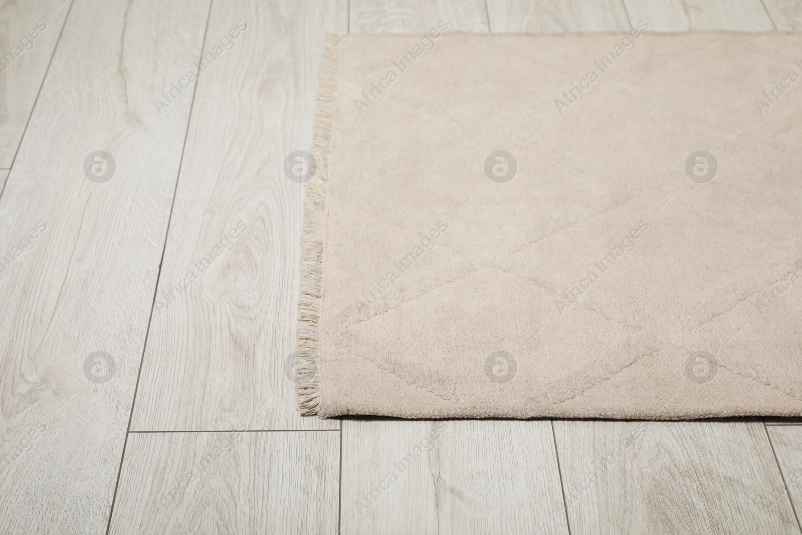 Photo of Soft beige carpet on white laminated floor indoors, space for text