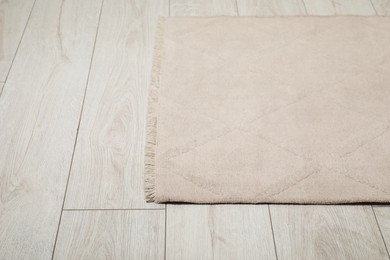 Photo of Soft beige carpet on white laminated floor indoors, space for text