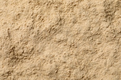 Photo of Heap of buckwheat flour as background, top view