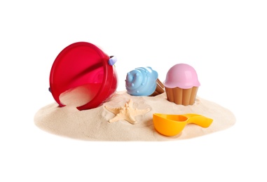 Set of plastic beach toys and pile of sand on white background