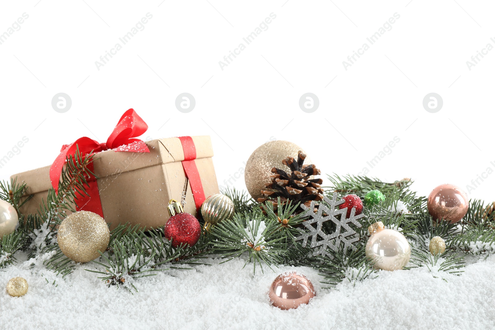 Photo of Fir branches, Christmas decoration and snow against white background