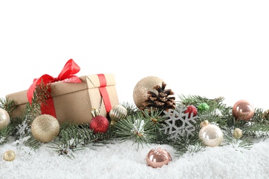 Fir branches, Christmas decoration and snow against white background