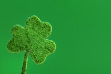 Photo of Decorative clover leaf on green background, space for text. Saint Patrick's Day celebration
