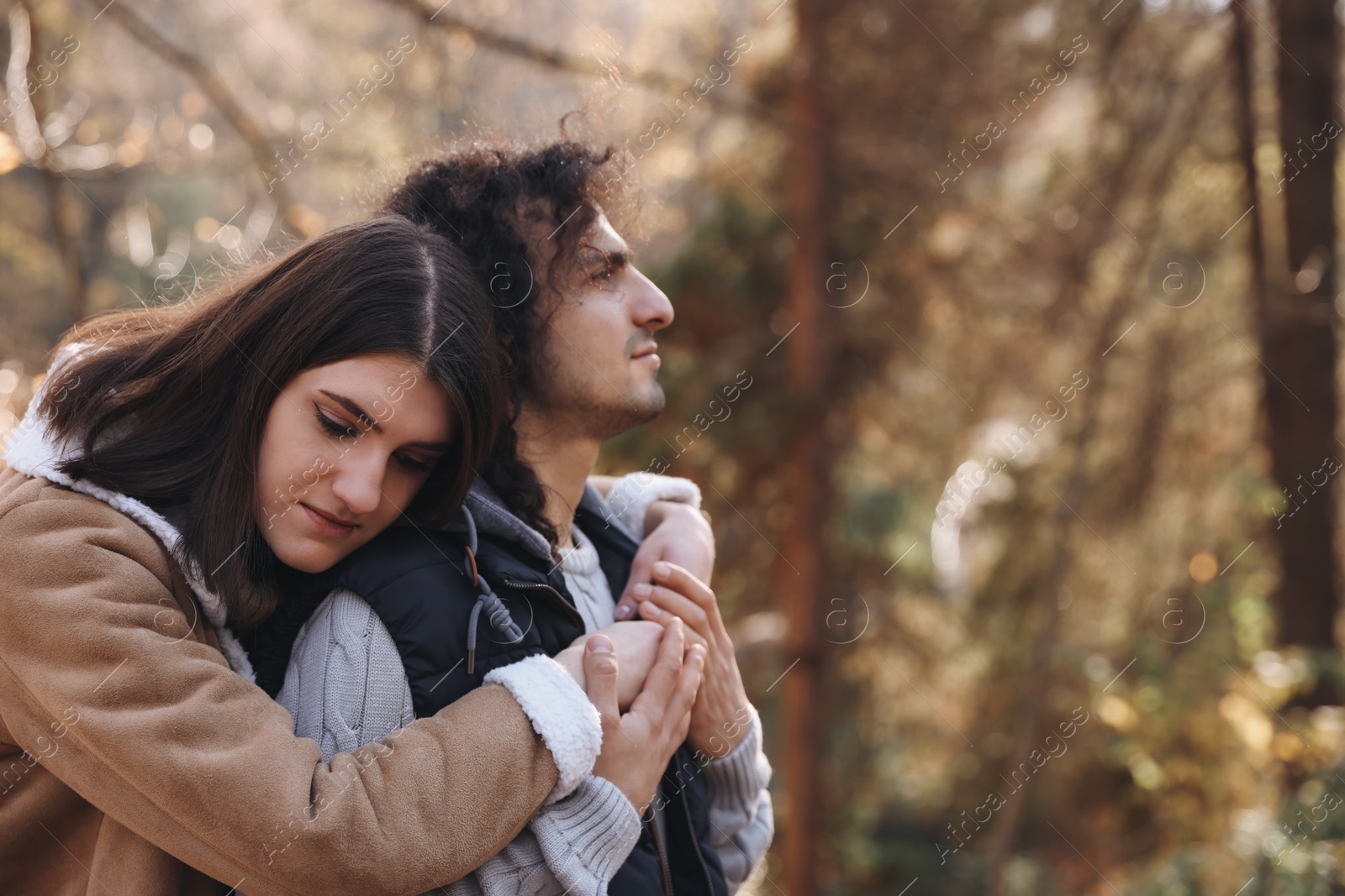 Photo of Young couple spending time together in autumn park, space for text. Dating agency