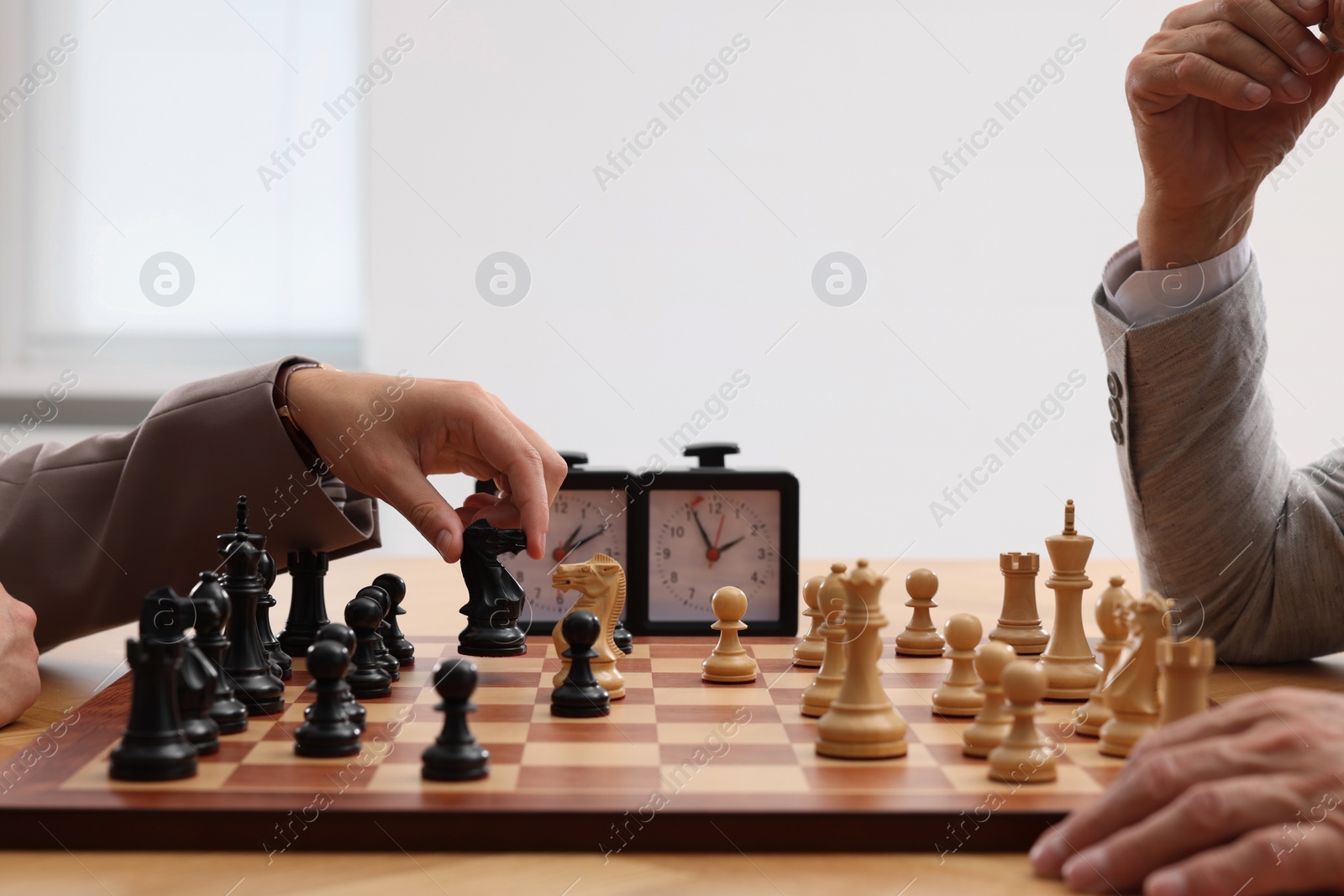 Photo of Men playing chess during tournament at table indoors, closeup