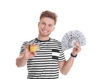 Happy young man with money and credit card on white background