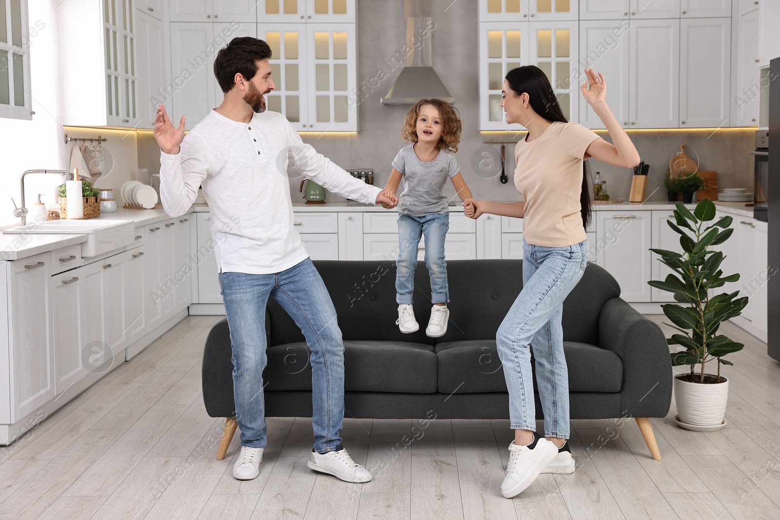 Photo of Happy family dancing and having fun at home