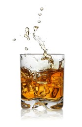 Photo of Whiskey splashing out of glass on white background