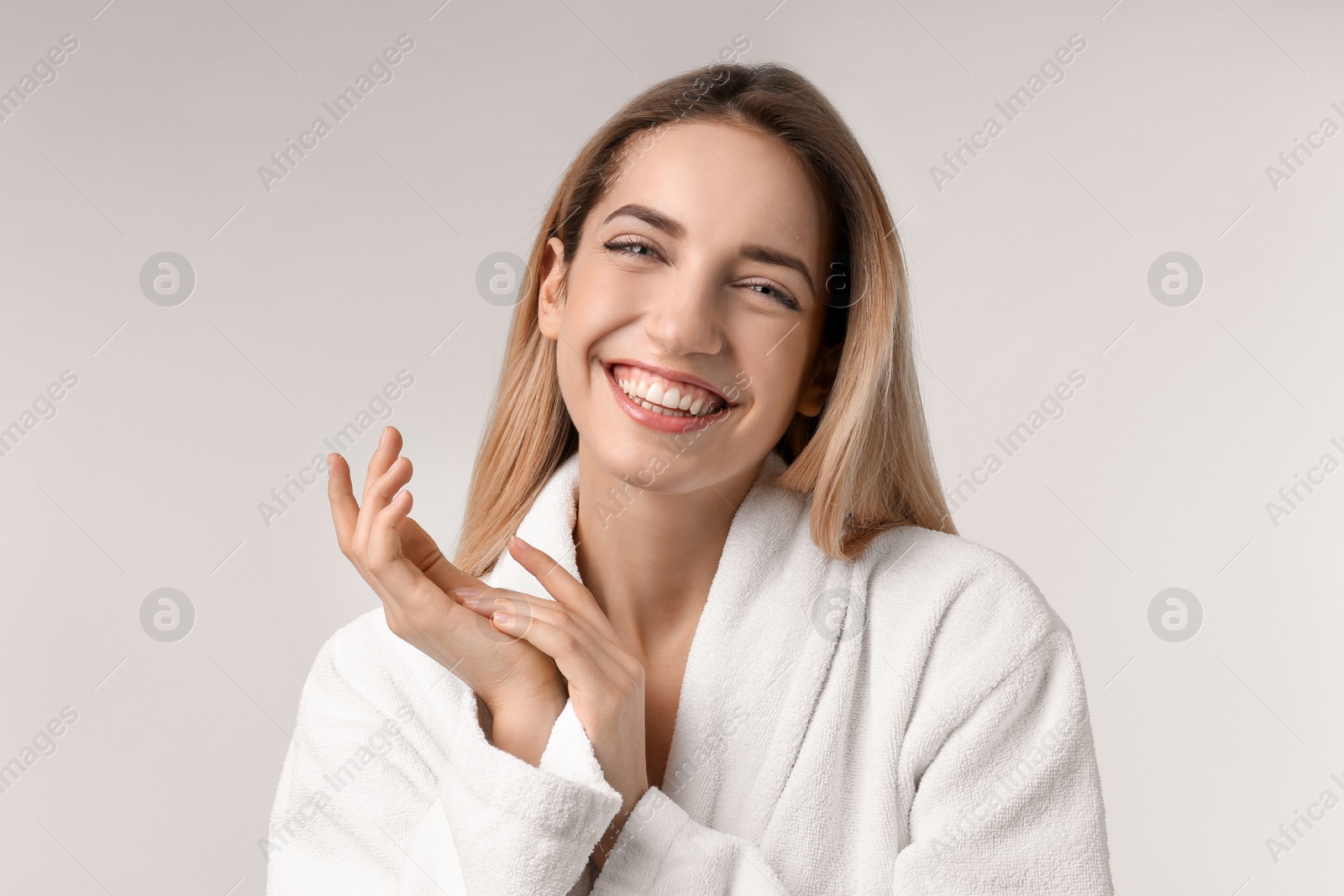 Photo of Beautiful young woman with silky skin on light background