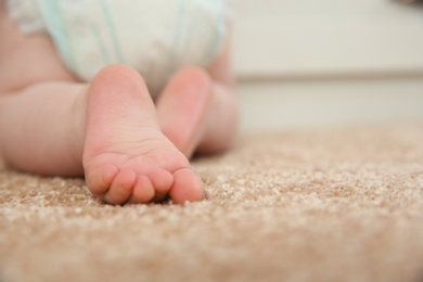 Cute little baby crawling on carpet indoors, closeup with space for text