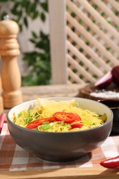 Photo of Stir-fry. Tasty noodles with vegetables and meat in bowl on table