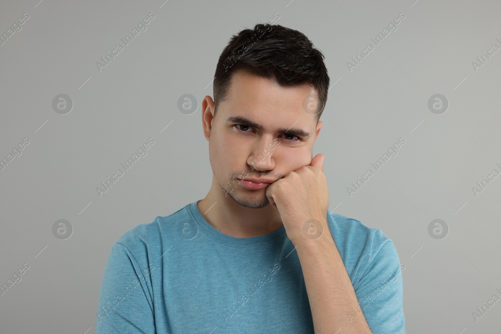 Photo of Portrait of resentful man on grey background