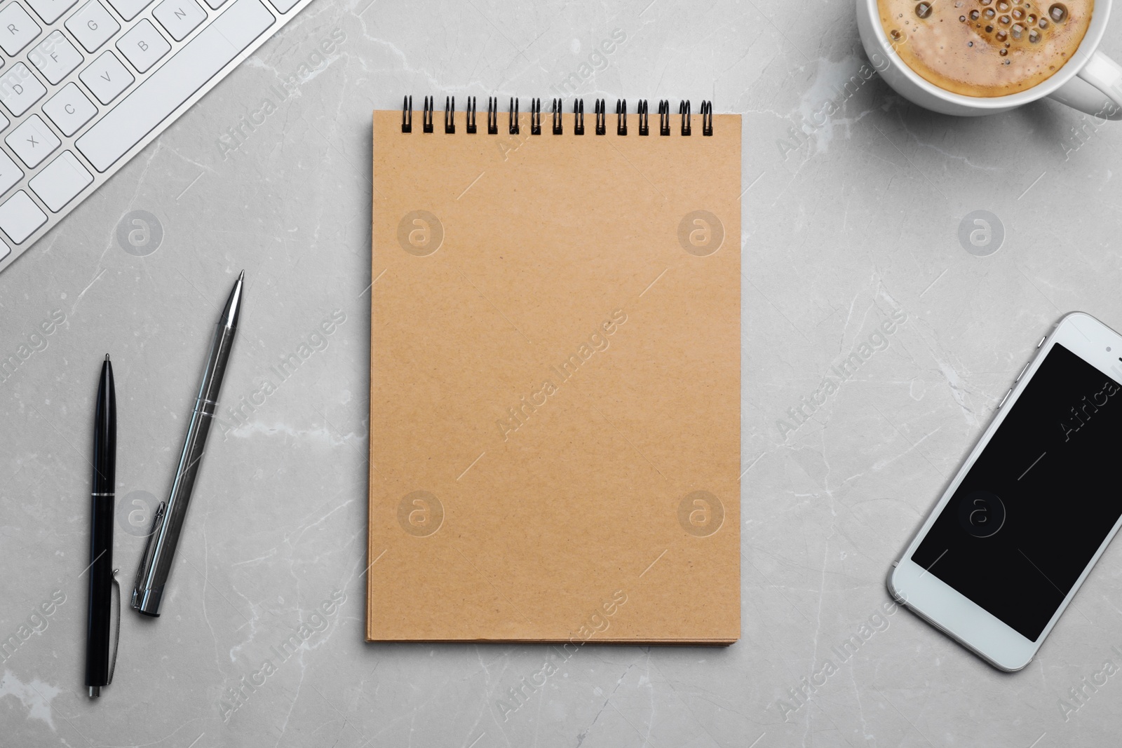 Photo of Flat lay composition with notebook, smartphone and cup of coffee on grey background