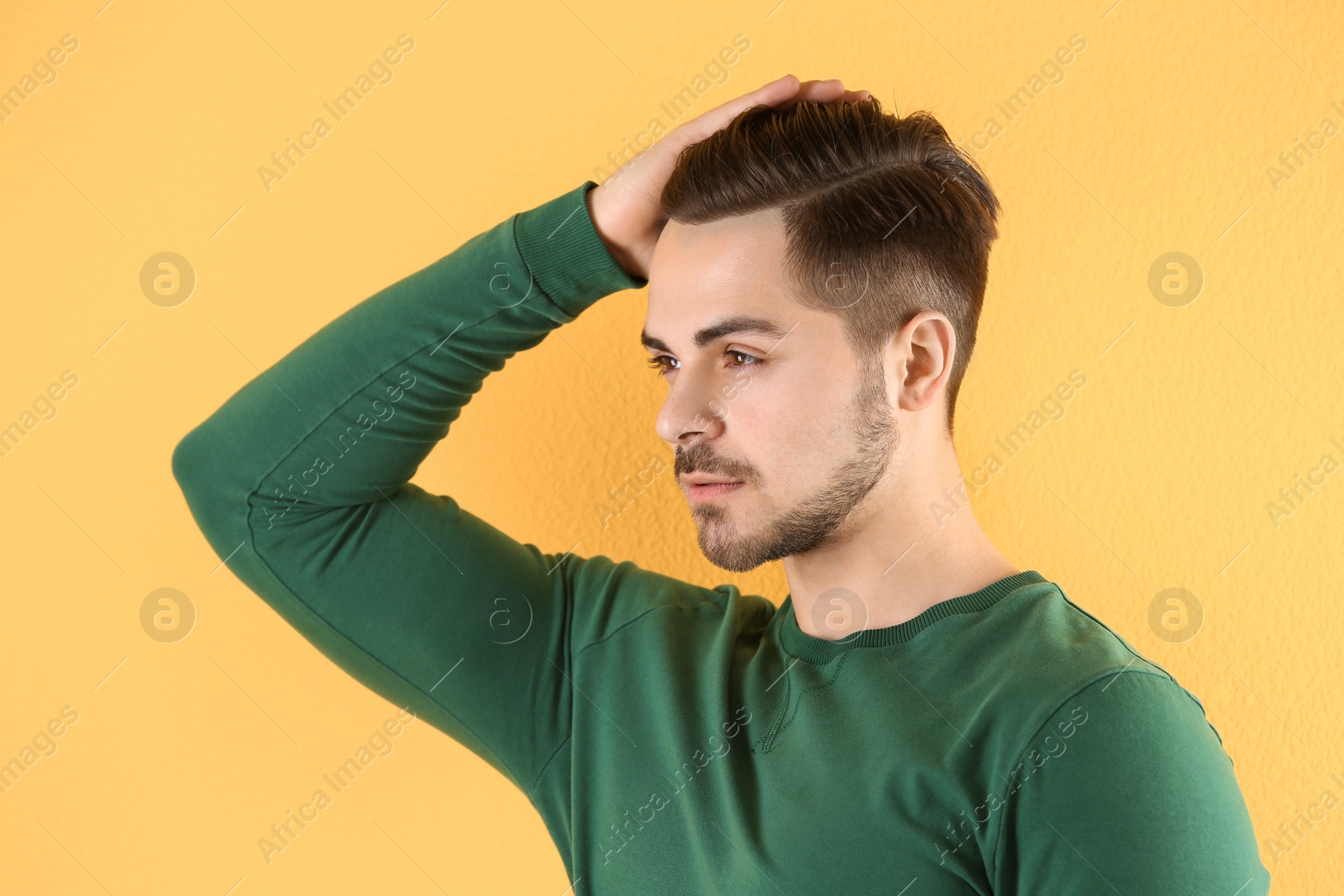 Photo of Portrait of young man with beautiful hair on color background