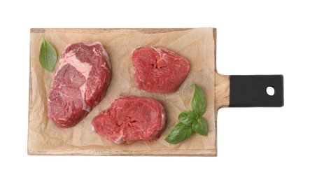 Fresh raw cut beef with basil leaves isolated on white, top view