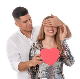 Photo of Man surprising his girlfriend with gift on white background. Valentine's day celebration