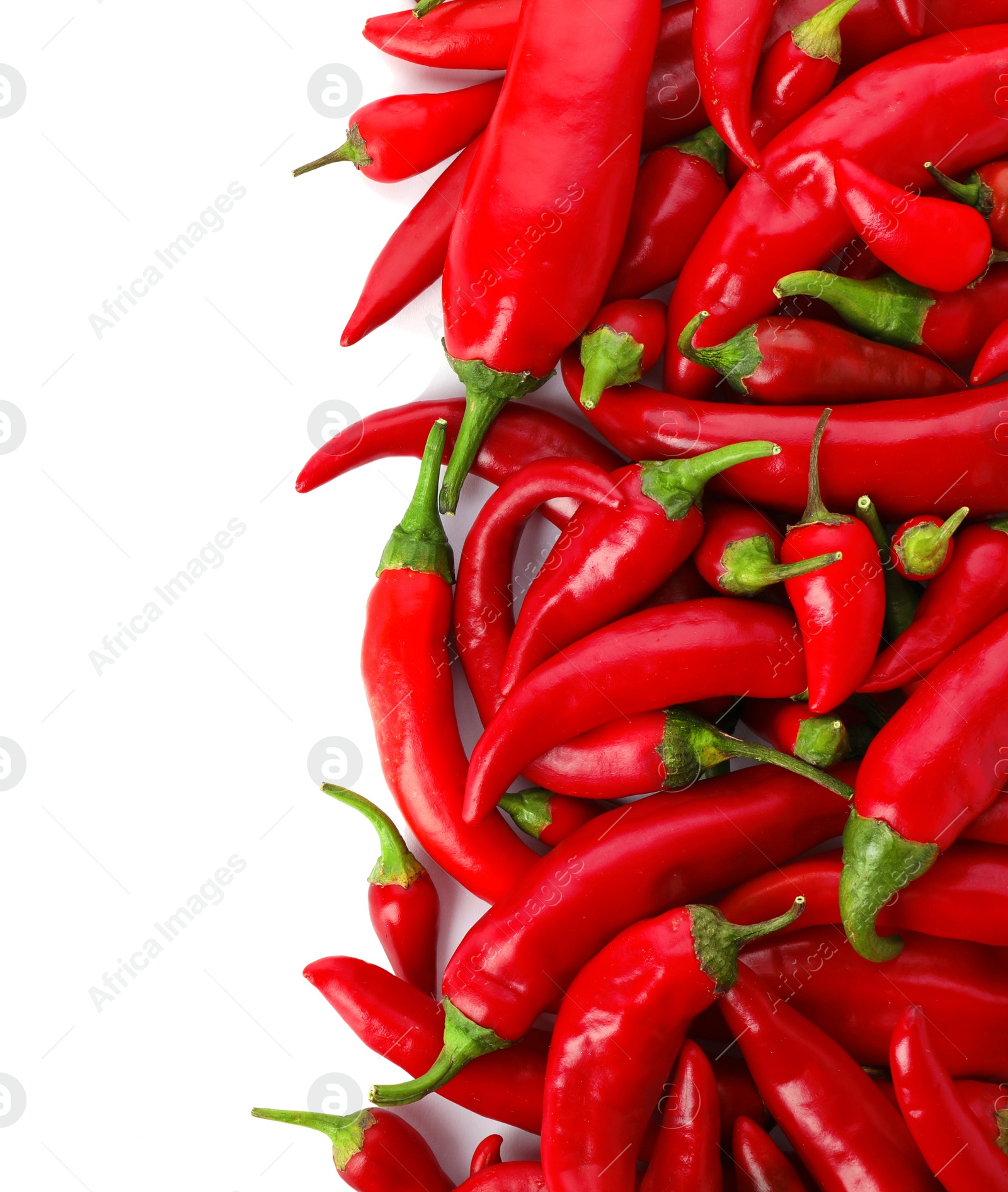 Photo of Red chili peppers on white background, top view. Space for text