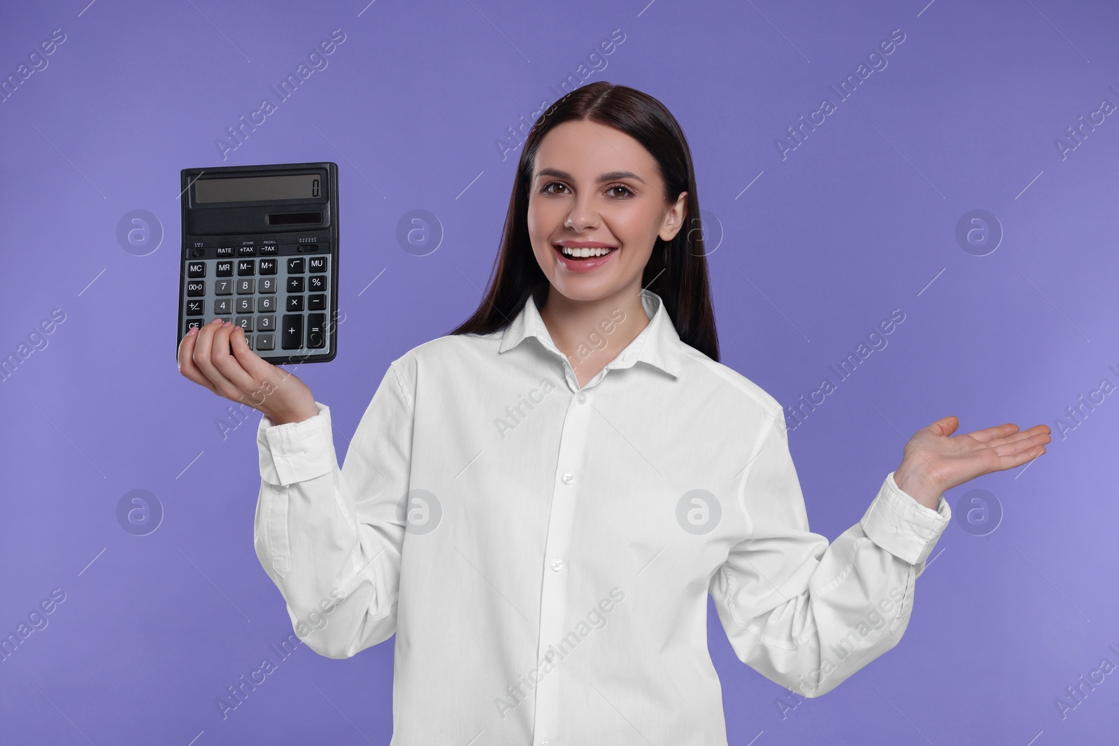 Photo of Happy accountant with calculator on purple background
