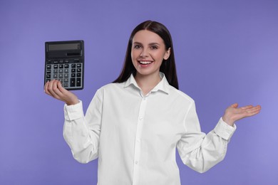 Happy accountant with calculator on purple background