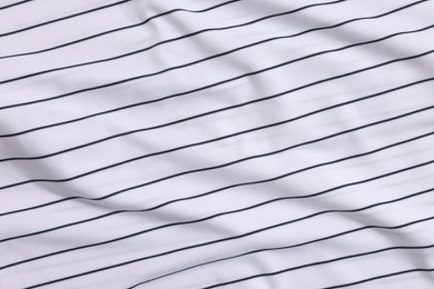 Photo of Striped baseball uniform as background, top view