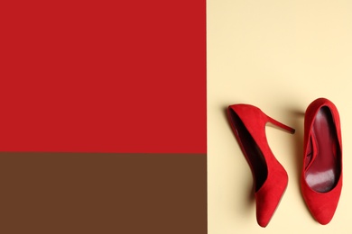 Stylish high heel shoes on color background, top view. Space for text