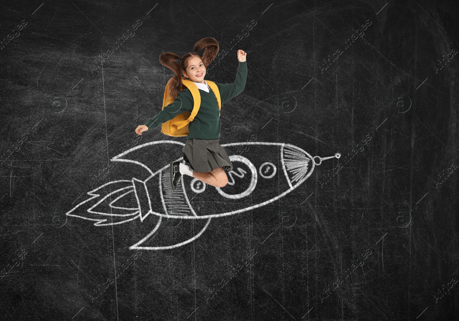 Image of Way to knowledge. Schoolgirl and chalked rocket on blackboard